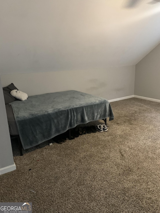 bedroom featuring dark colored carpet, vaulted ceiling, and pool table