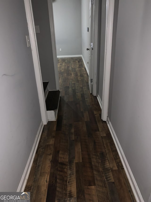 corridor featuring dark wood-type flooring