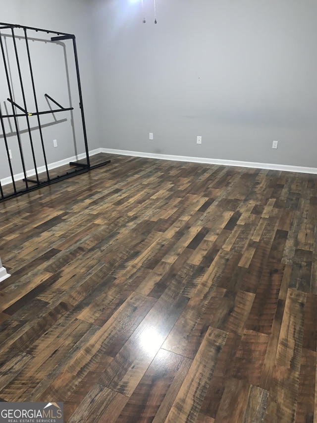 spare room featuring dark wood-type flooring