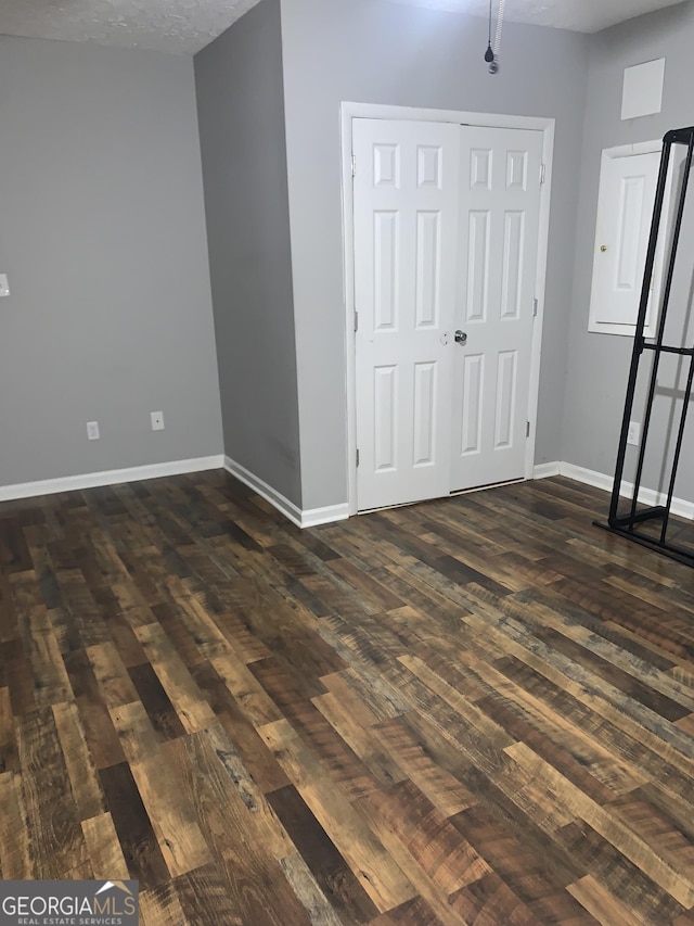 interior space featuring dark hardwood / wood-style floors and a textured ceiling