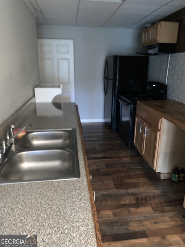 kitchen with a paneled ceiling, ventilation hood, sink, dark hardwood / wood-style floors, and black / electric stove