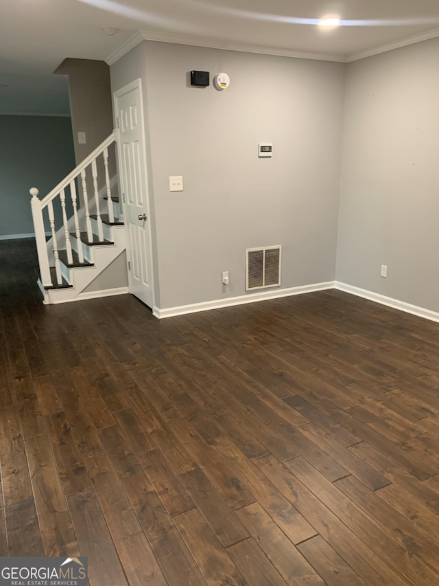 empty room featuring dark hardwood / wood-style floors and ornamental molding