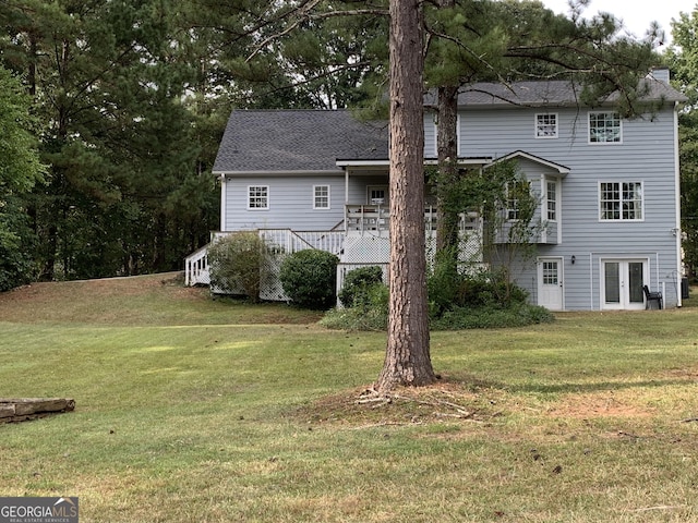 back of house with a yard, a wooden deck, and french doors