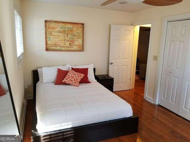 bedroom featuring hardwood / wood-style flooring, ceiling fan, and a closet