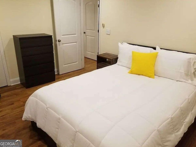 bedroom featuring dark wood-type flooring