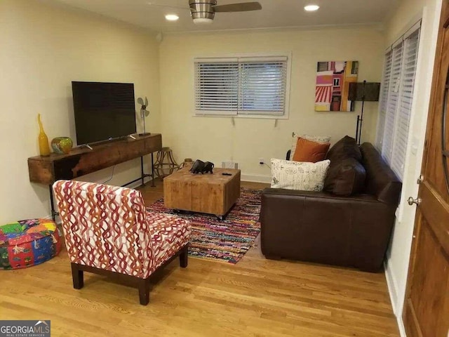 living room featuring ceiling fan and light hardwood / wood-style floors