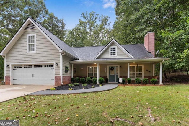 view of front facade with covered porch, a front lawn, and a garage