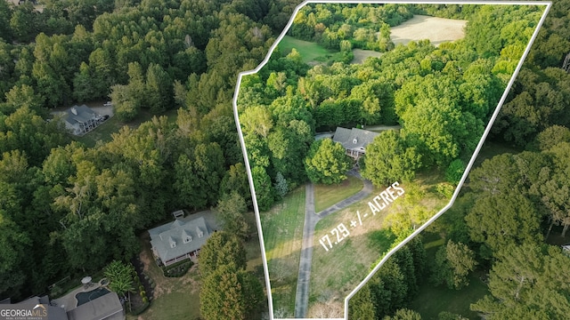 birds eye view of property with a forest view