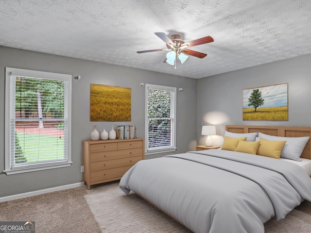 carpeted bedroom with a textured ceiling and ceiling fan