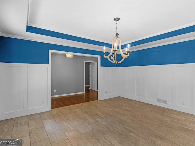 unfurnished dining area with crown molding and an inviting chandelier