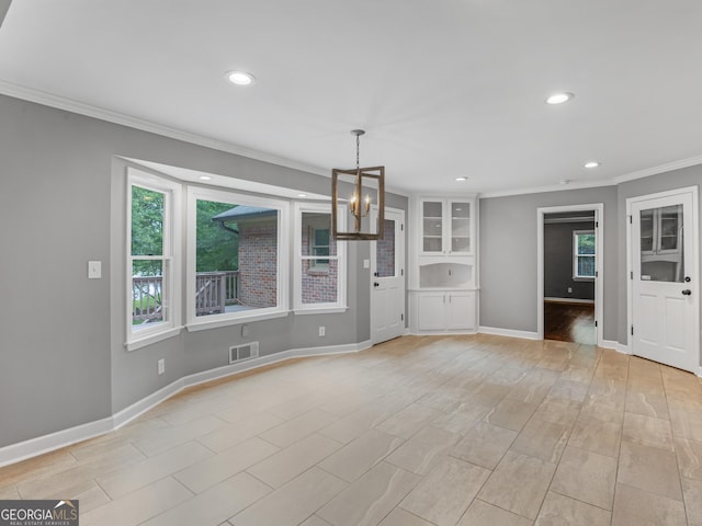 unfurnished living room featuring a chandelier and crown molding