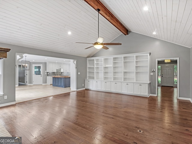 unfurnished living room with vaulted ceiling with beams, dark wood-type flooring, wood ceiling, and ceiling fan with notable chandelier