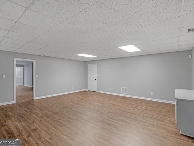 interior space featuring hardwood / wood-style floors and a paneled ceiling