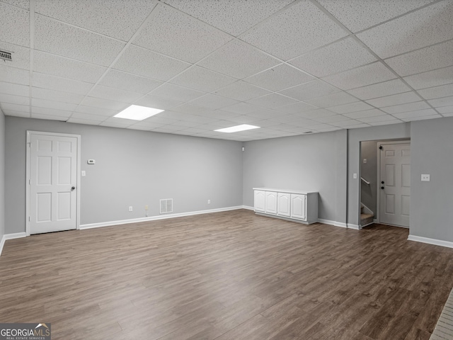 basement with wood-type flooring and a drop ceiling