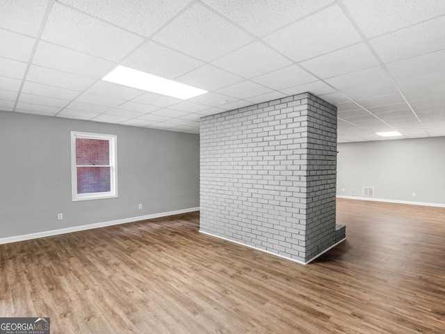 basement with hardwood / wood-style floors and a drop ceiling