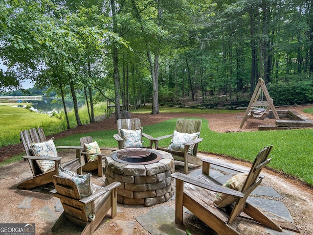 view of patio with a water view and a fire pit