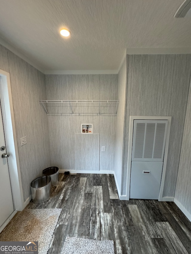 washroom with hookup for a washing machine, dark hardwood / wood-style floors, and wooden walls