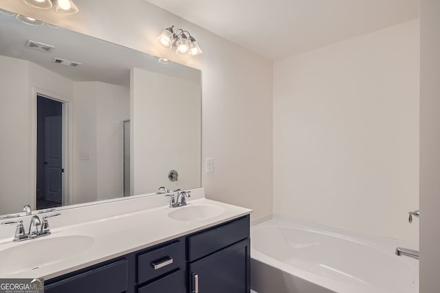 bathroom with a tub to relax in and vanity