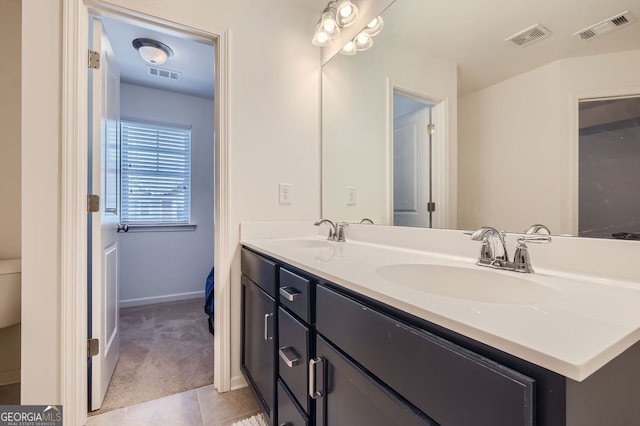 bathroom with tile patterned flooring and vanity