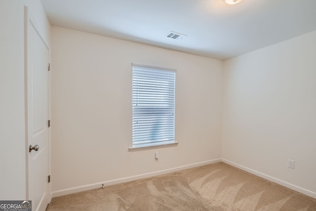 unfurnished room featuring light colored carpet