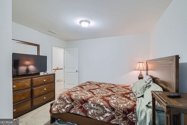 bedroom with light colored carpet