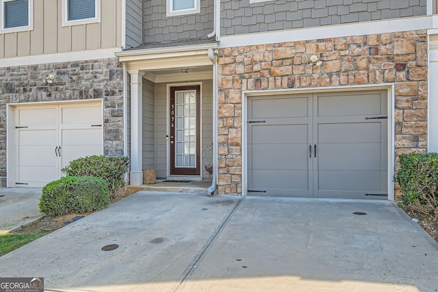 view of exterior entry with a garage