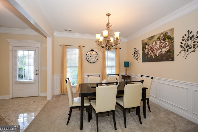 dining area with a notable chandelier and crown molding