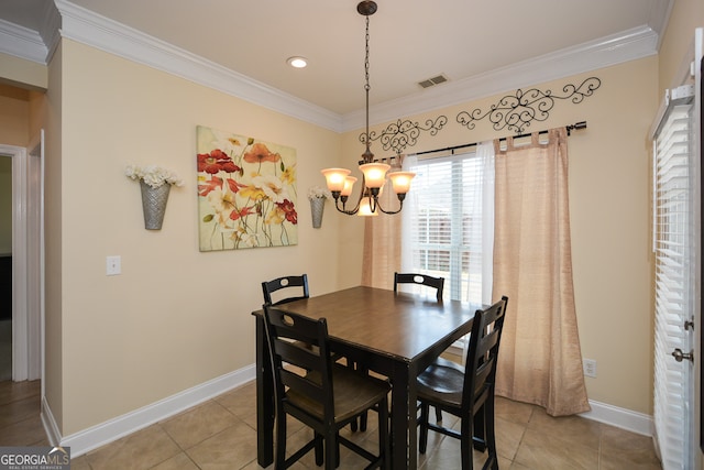 dining area with an inviting chandelier, crown molding, and tile patterned floors