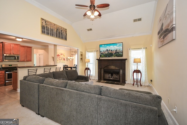 living room featuring ceiling fan, lofted ceiling, plenty of natural light, and ornamental molding