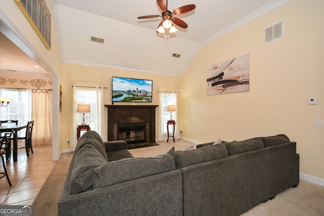 living room featuring light tile patterned flooring, ceiling fan, crown molding, and plenty of natural light