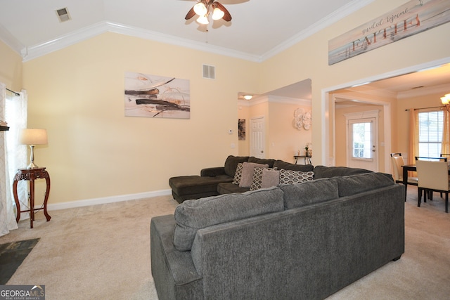 living room featuring ornamental molding, light colored carpet, vaulted ceiling, and ceiling fan