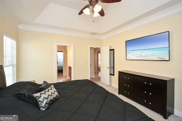 carpeted bedroom featuring ceiling fan, a raised ceiling, ornamental molding, and multiple windows