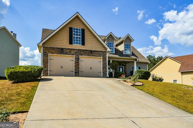 view of front of house featuring a front lawn and a garage