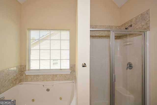 bathroom featuring shower with separate bathtub