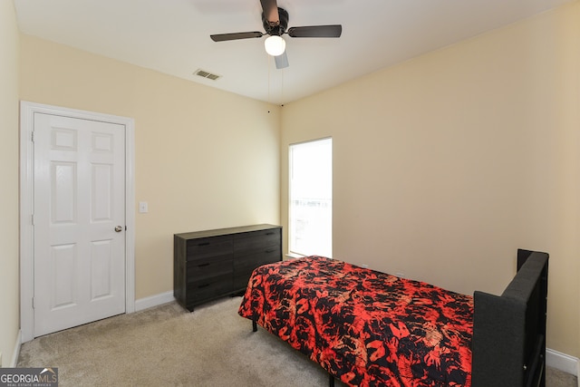 bedroom featuring light colored carpet and ceiling fan