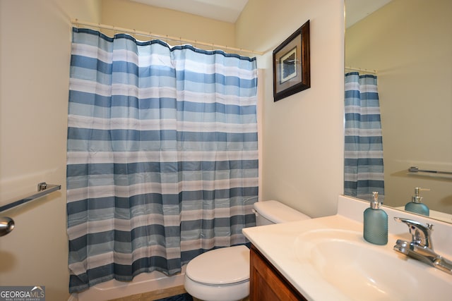 bathroom featuring a shower with curtain, vanity, and toilet