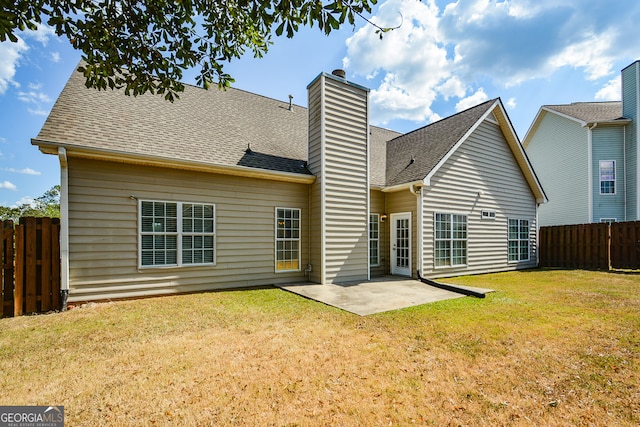 back of house with a yard and a patio area