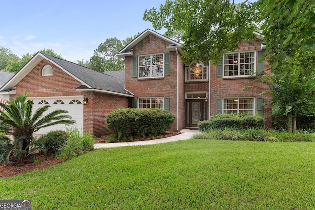 view of front of house featuring a garage and a front yard