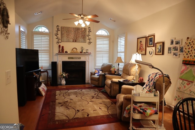 living room featuring lofted ceiling, a wealth of natural light, and hardwood / wood-style flooring