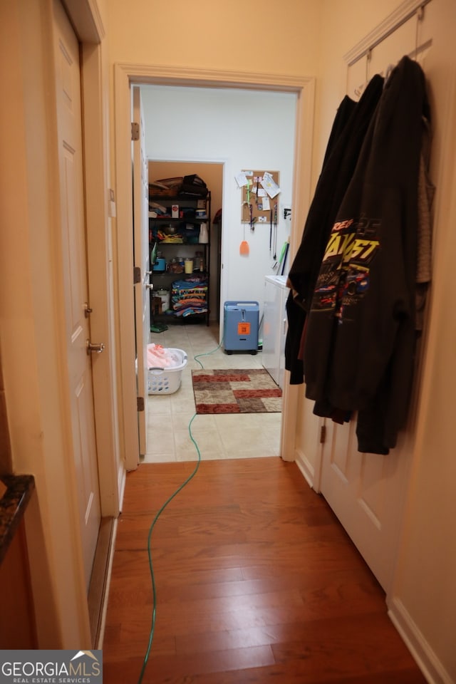 hallway with hardwood / wood-style floors