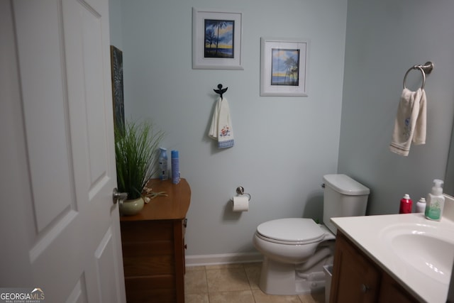 bathroom with vanity, toilet, and tile patterned floors