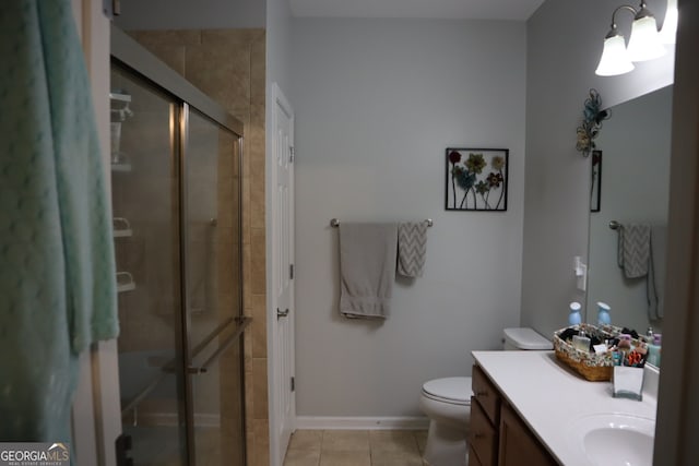 bathroom featuring vanity, toilet, an enclosed shower, and tile patterned floors