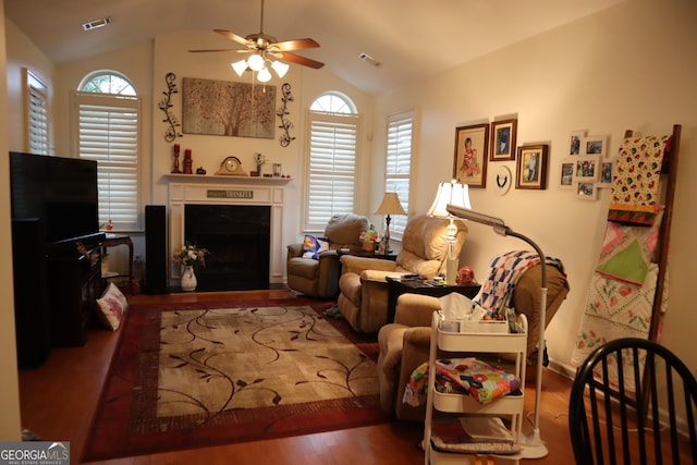 living room featuring hardwood / wood-style floors, ceiling fan, and vaulted ceiling