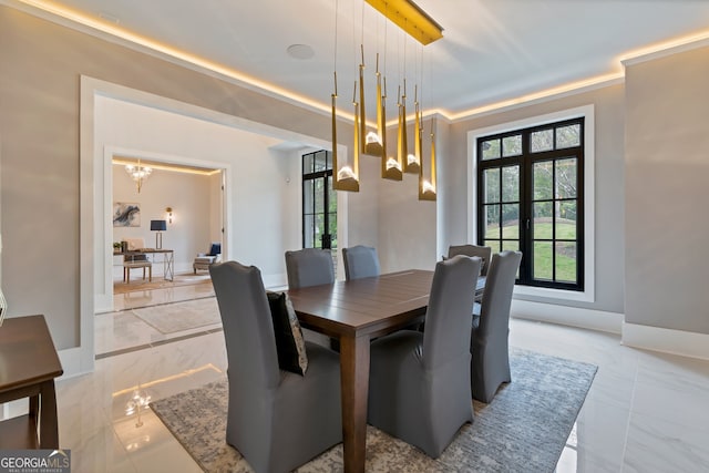 dining room featuring french doors, a notable chandelier, and ornamental molding