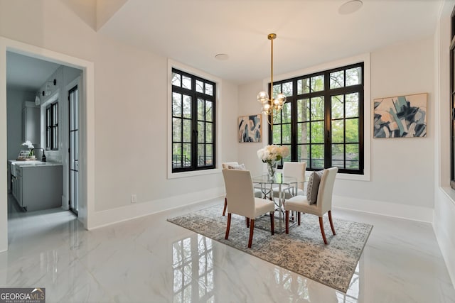 dining area featuring a healthy amount of sunlight and a notable chandelier