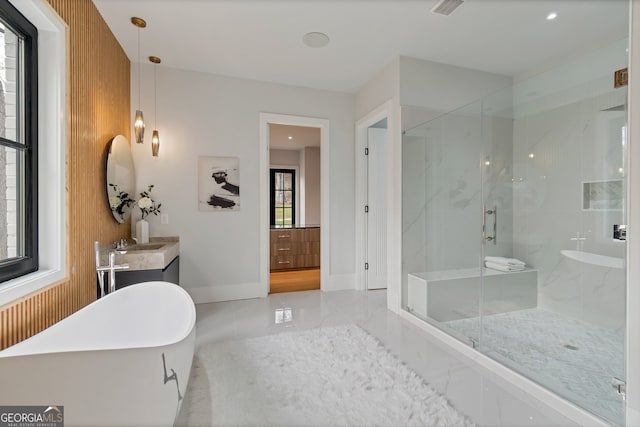 bathroom featuring separate shower and tub and vanity