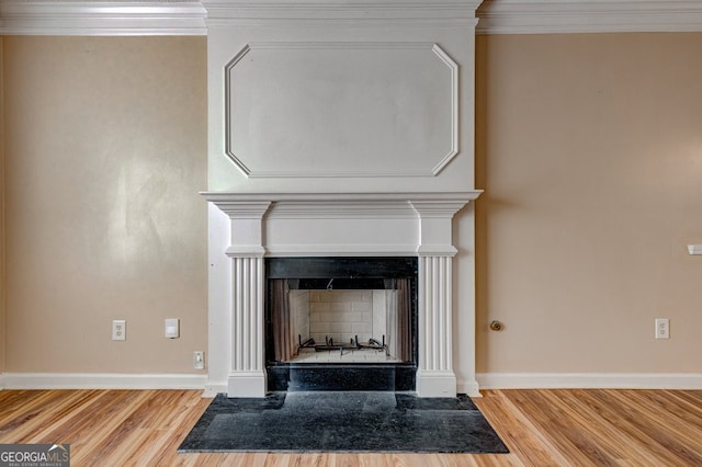 details with ornamental molding and hardwood / wood-style floors