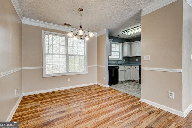 kitchen featuring white cabinetry, black dishwasher, hanging light fixtures, and light hardwood / wood-style flooring