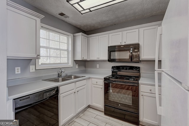 kitchen with white cabinetry, sink, a textured ceiling, and black appliances