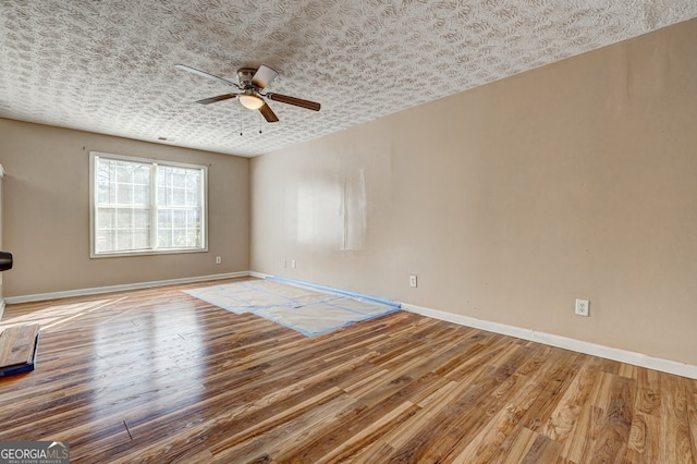 unfurnished room featuring hardwood / wood-style flooring and ceiling fan